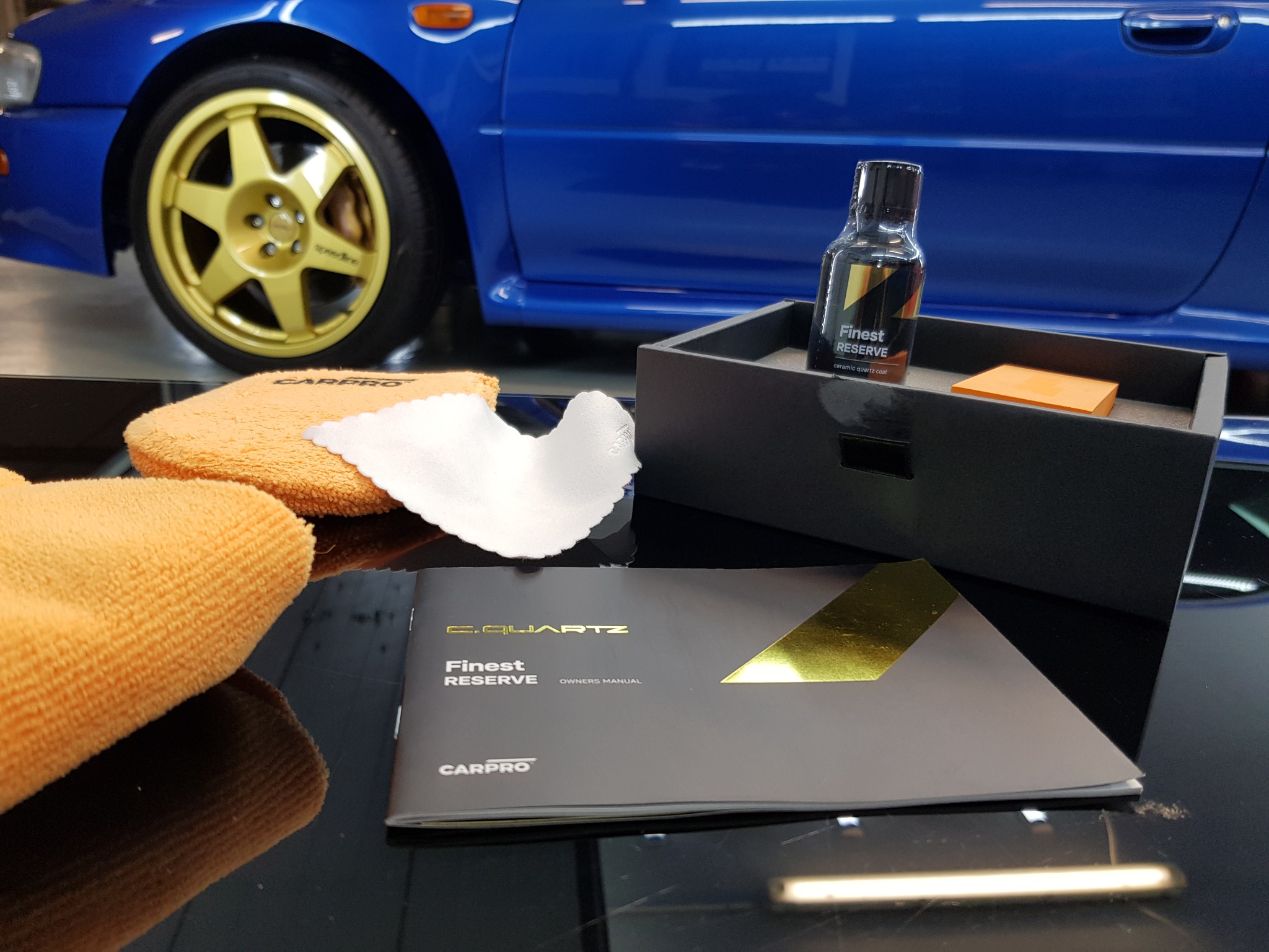 CARPRO keramički premaz i pribor uz plavi automobil